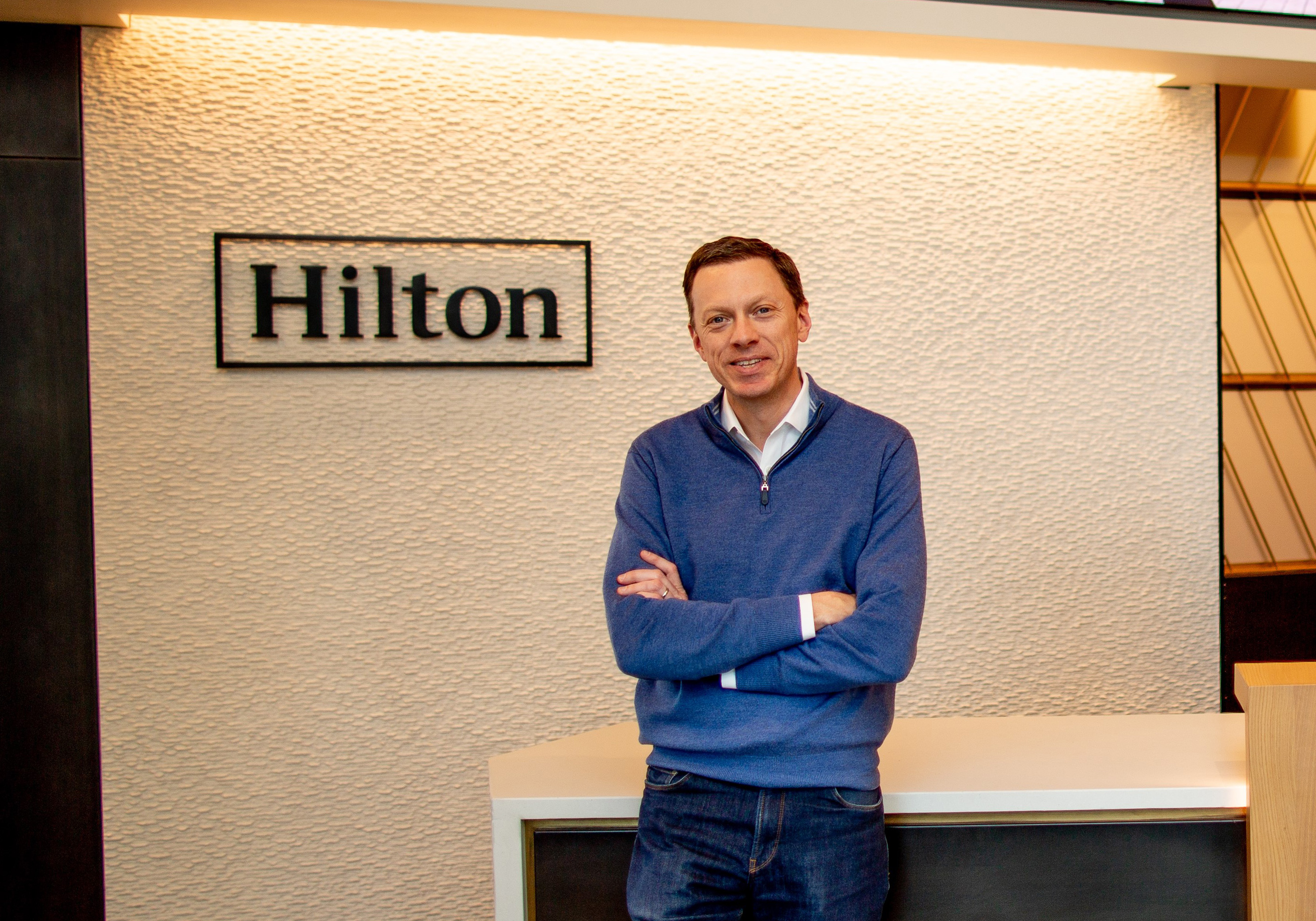 Kevin Jacobs in front of Hilton sign