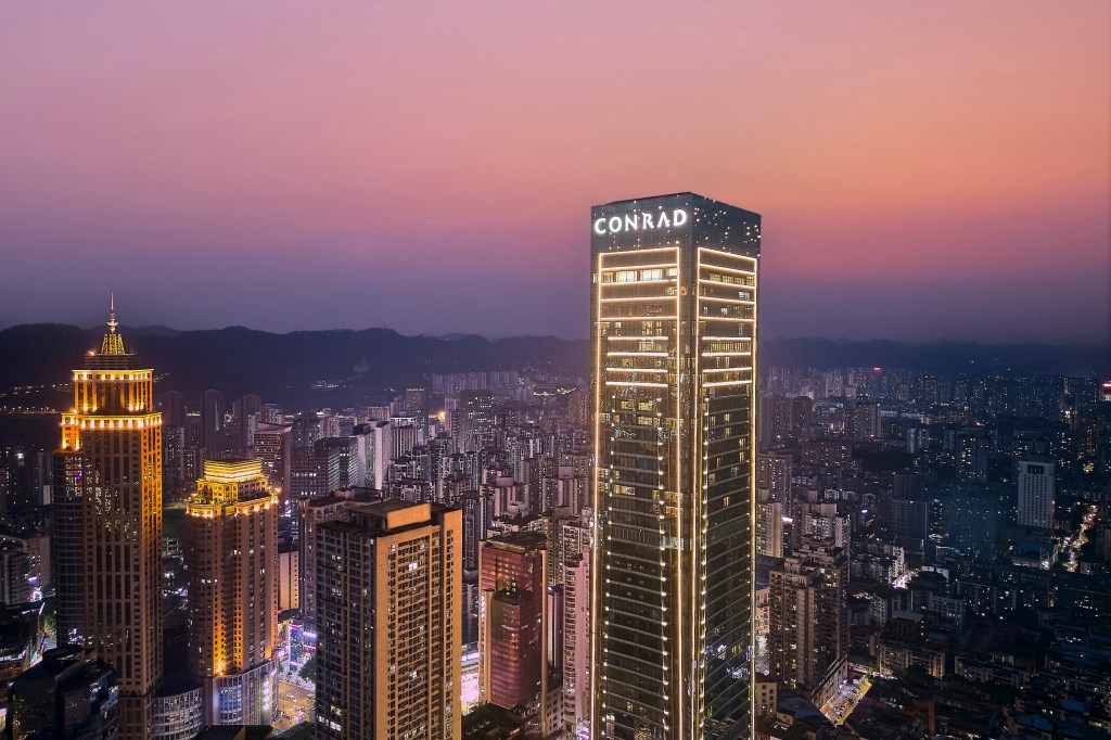 Conrad Chongqing - lit up skyline view at dusk