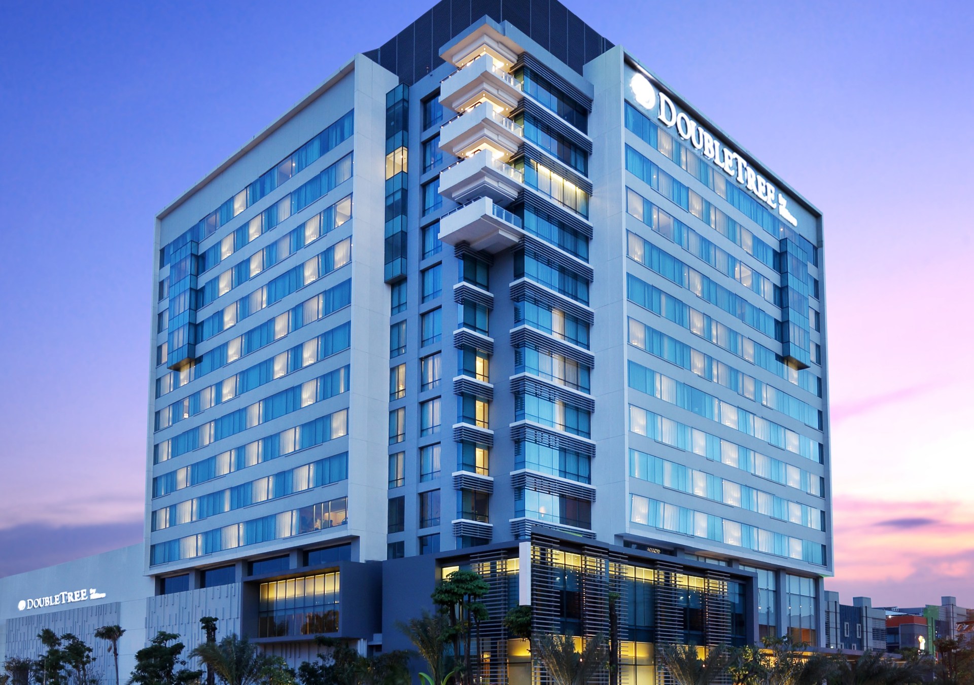 exterior facade of DoubleTree by Hilton Jakarta Kemayoran at dusk