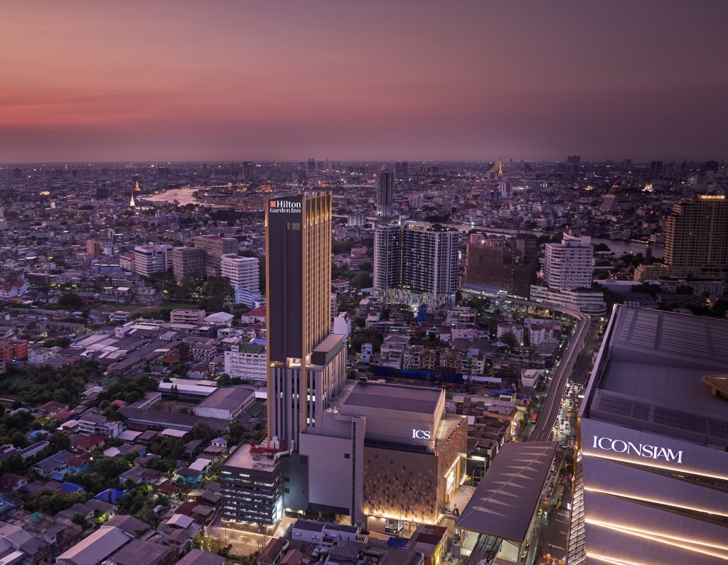 aerial exterior of Hilton Garden Inn Bangkok Riverside with Bangkok skyline