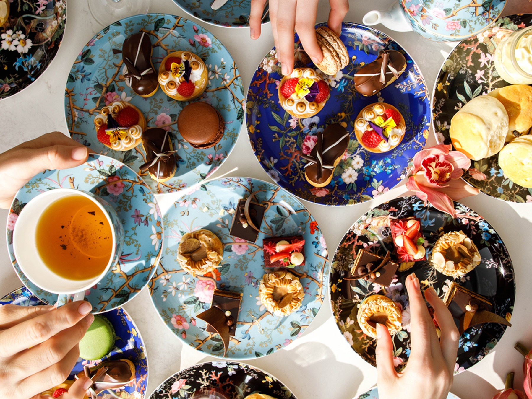 Hilton Adelaide - Christmas Day Buffet Lunch - hands reaching over plates and holding tea cups