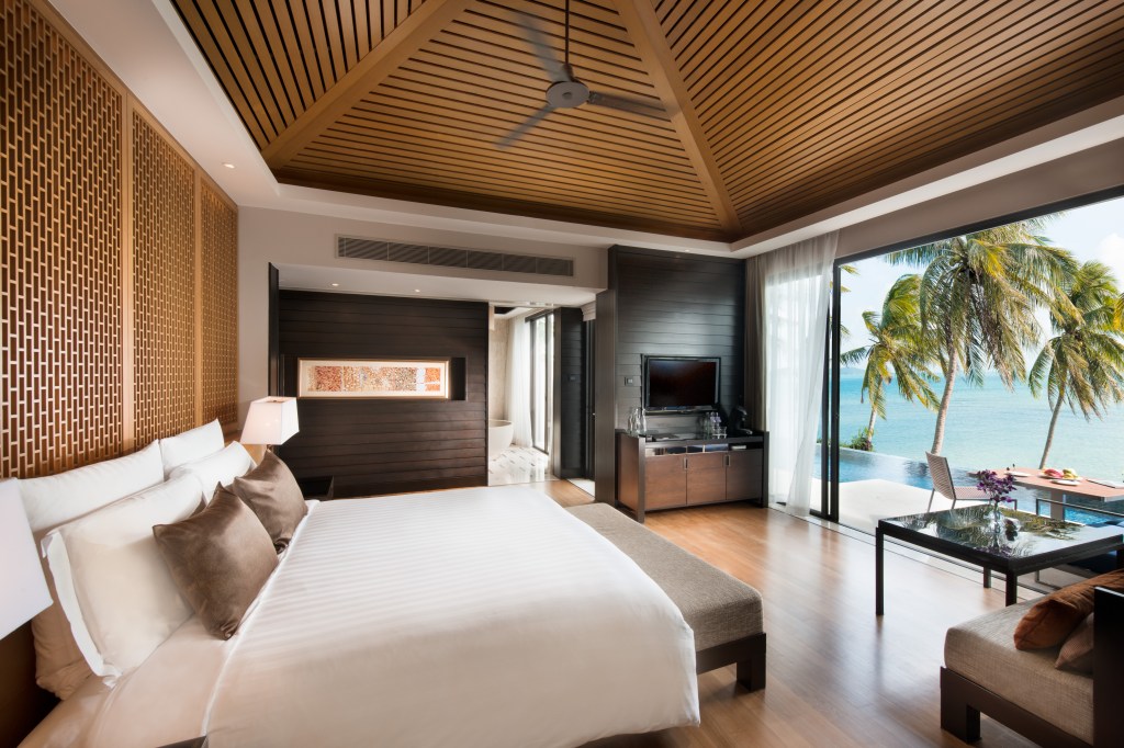 Conrad Koh Samui, One Bedroom, Sunset, Pool, Villa, cathedral ceiling, palm trees, infinity pool, framed artwork, outdoor dining, black coffee table, cushioned bench, table lamp, television, media center