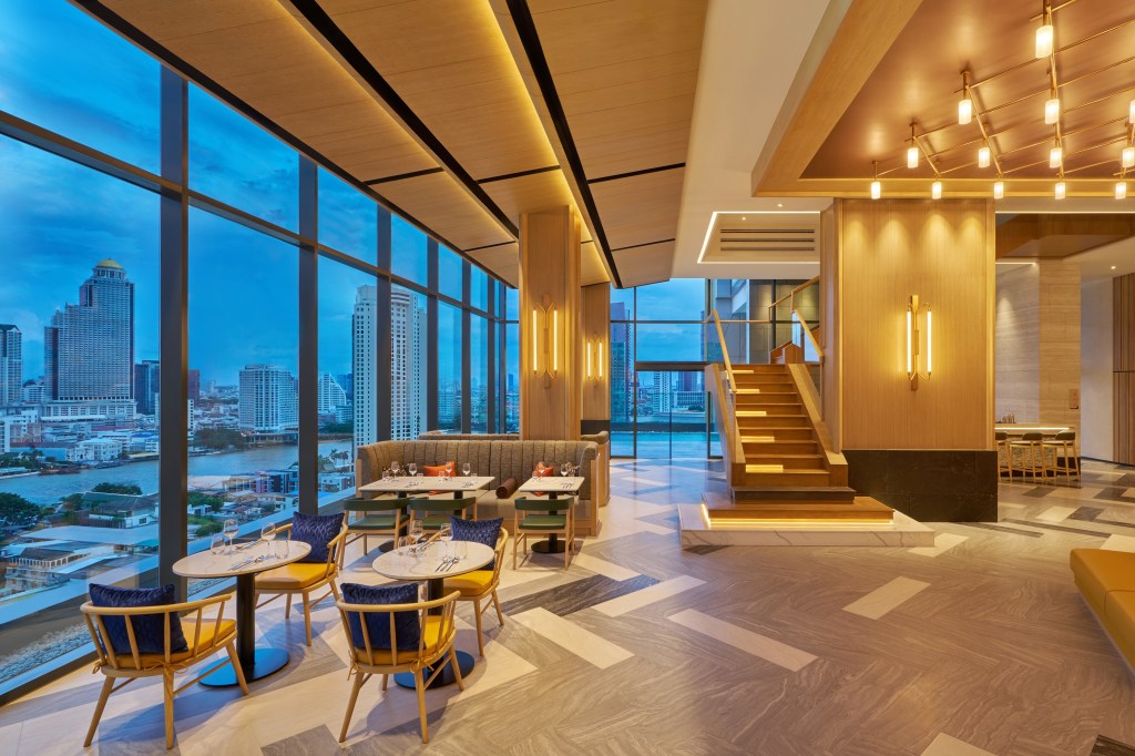 Hilton Garden Inn Bangkok Riverside, Together &amp; Co, dining area, city view, wooden stairs, bar, tall wall sconce indoor lighting, ceiling lights, floor to ceiling windows