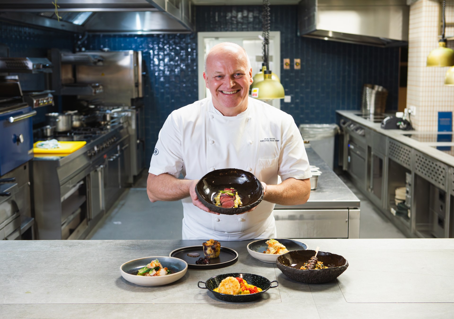 Chef Paul bates in the kitchen showing off his beautiful and delicious food dishes