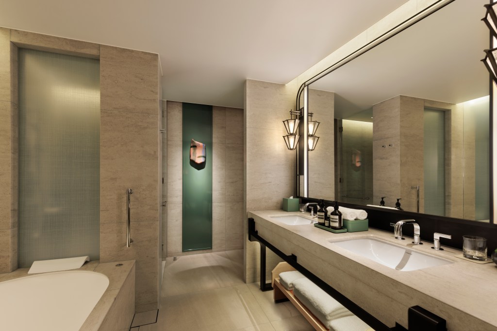 Waldorf Astoria Osaka - Deluxe Premier Guest Room Bathroom, large mirror, sink, bathtub, green accents, folded towels