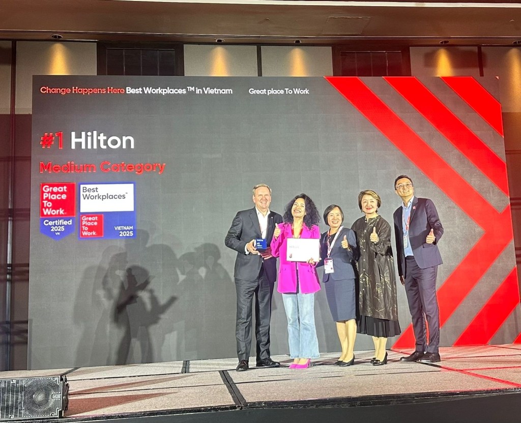 Hilton Named #1 Best Workplace in Vietnam - Great Place To Work Awards Ceremony with group posing on awards stage