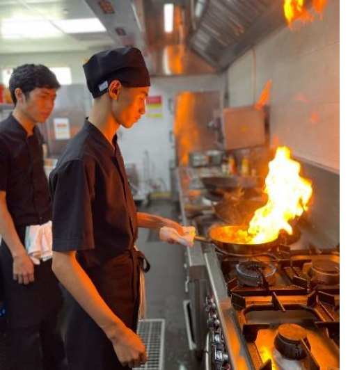 Hilton Garden Inn Da Nang Commis chef Tran Duc Minh receiving instructions from Le Dinh Nguyen Anh - Hilton Named #1 Best Workplace in Vietnam