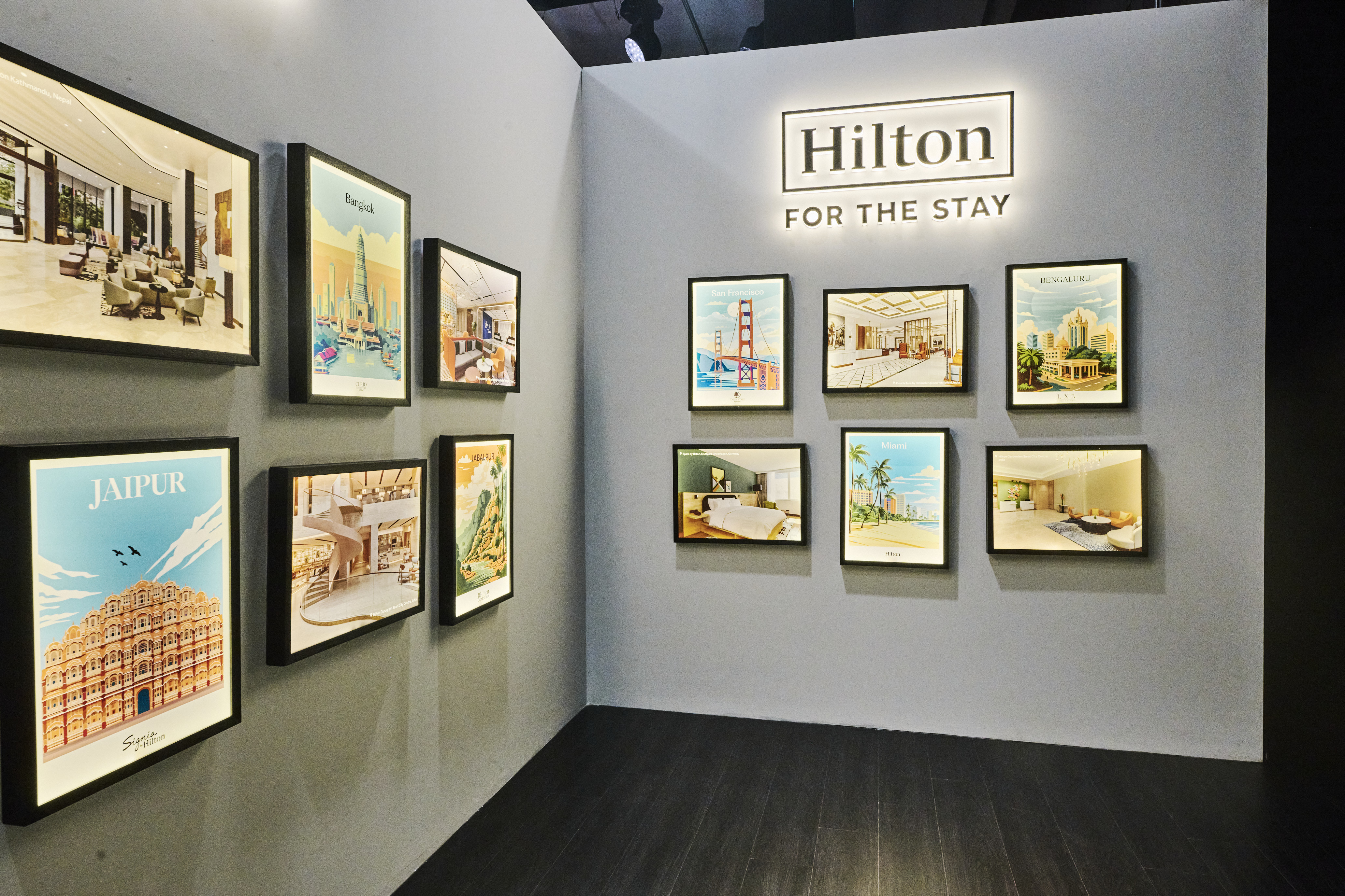 Hilton's Brand Showcase in India - New Arrivals artwork featuring posters of cities around the world and Hilton photos