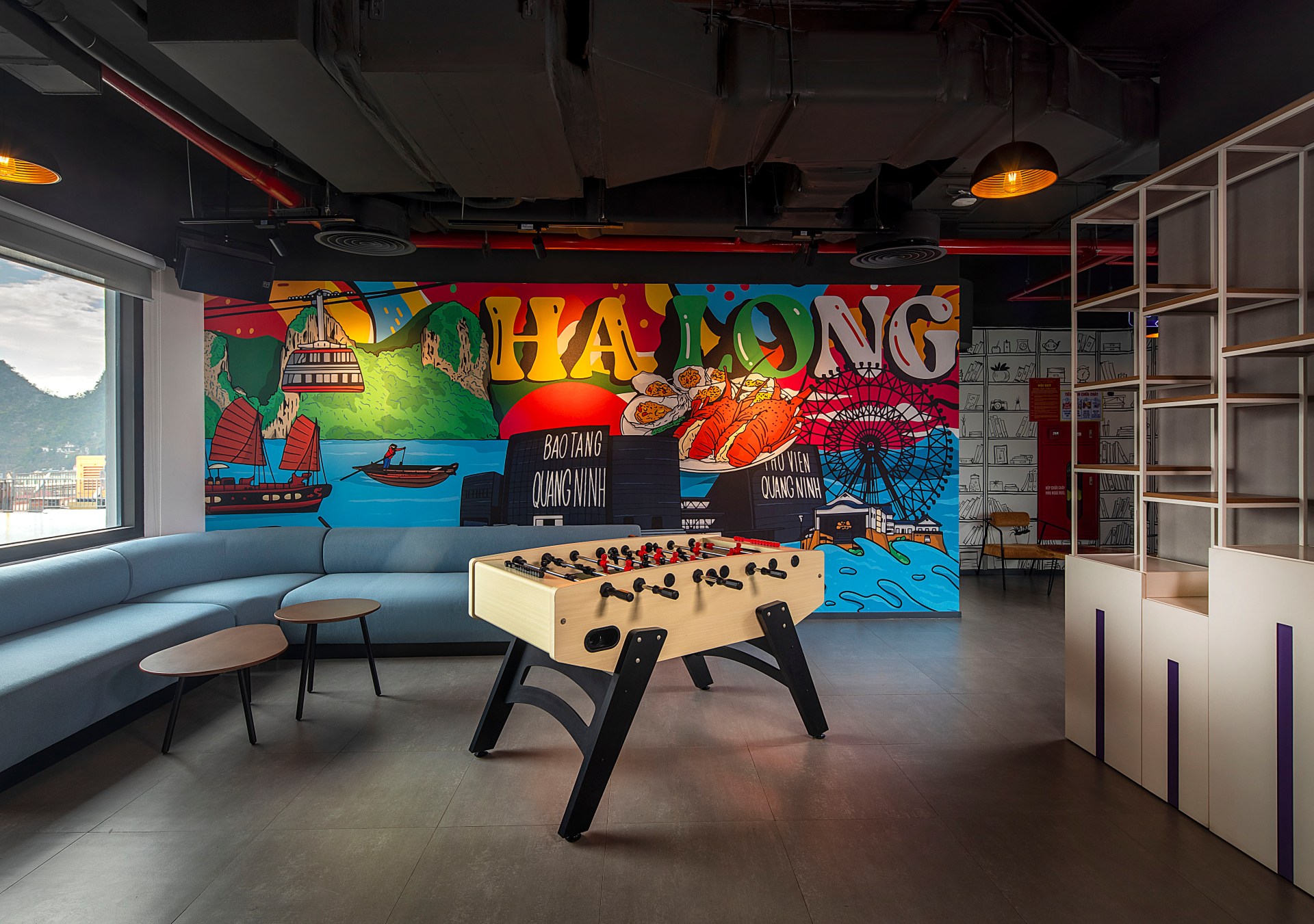 Tru By Hilton Ha Long Hon Gai Centre Mural, foosball table, mural wall art, blue couch with coffee tables