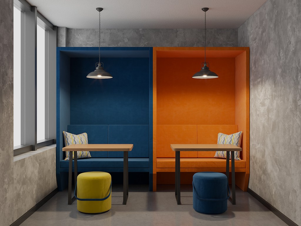 Tru by Hilton Co-Working Space with blue and orange booth seating and wooden tables and light gray and yellow round seats