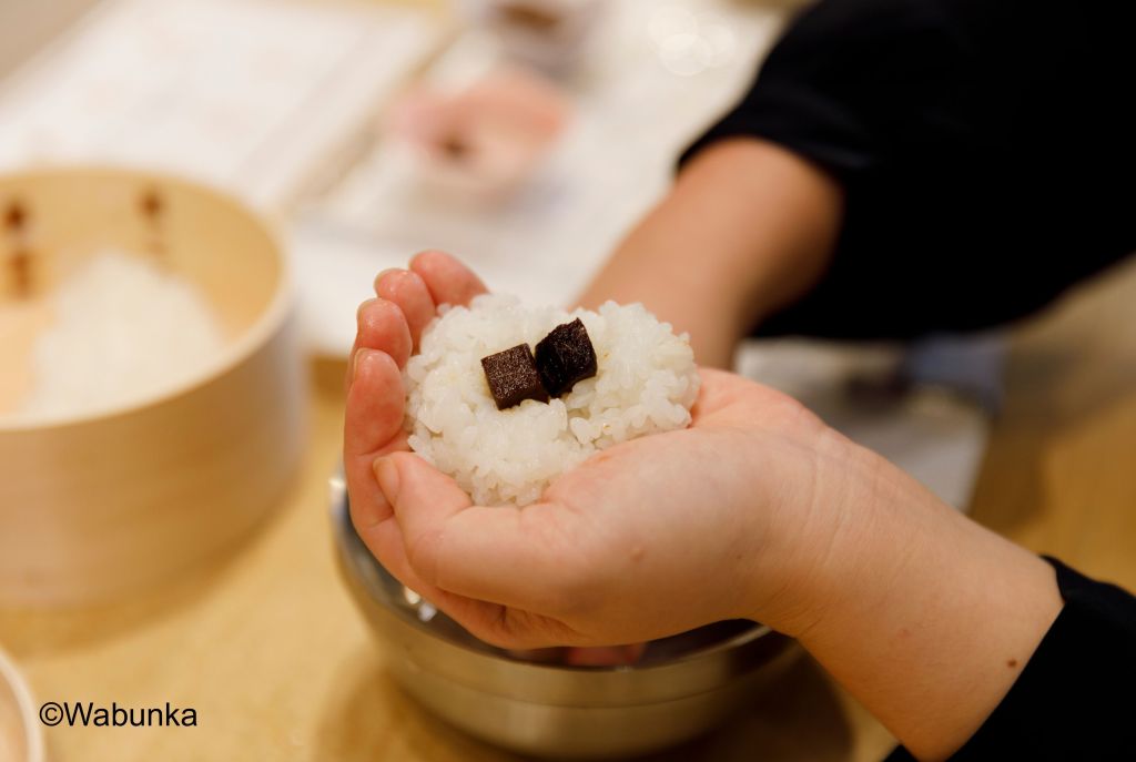 Conrad Tokyo, Onigiri Workshop, person crafting onigiri rice balls