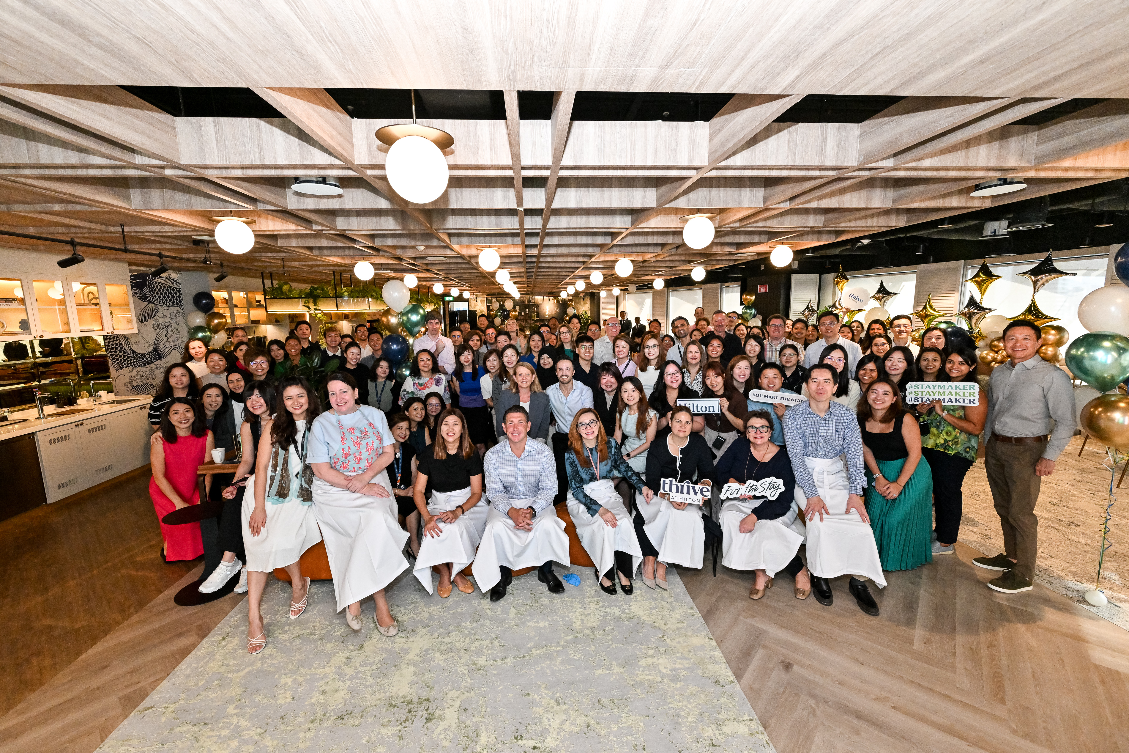 Large group of Hilton Team Members pose for a photo while celebrating Hilton being named No. 1 Best Place to Work in Asia 2025