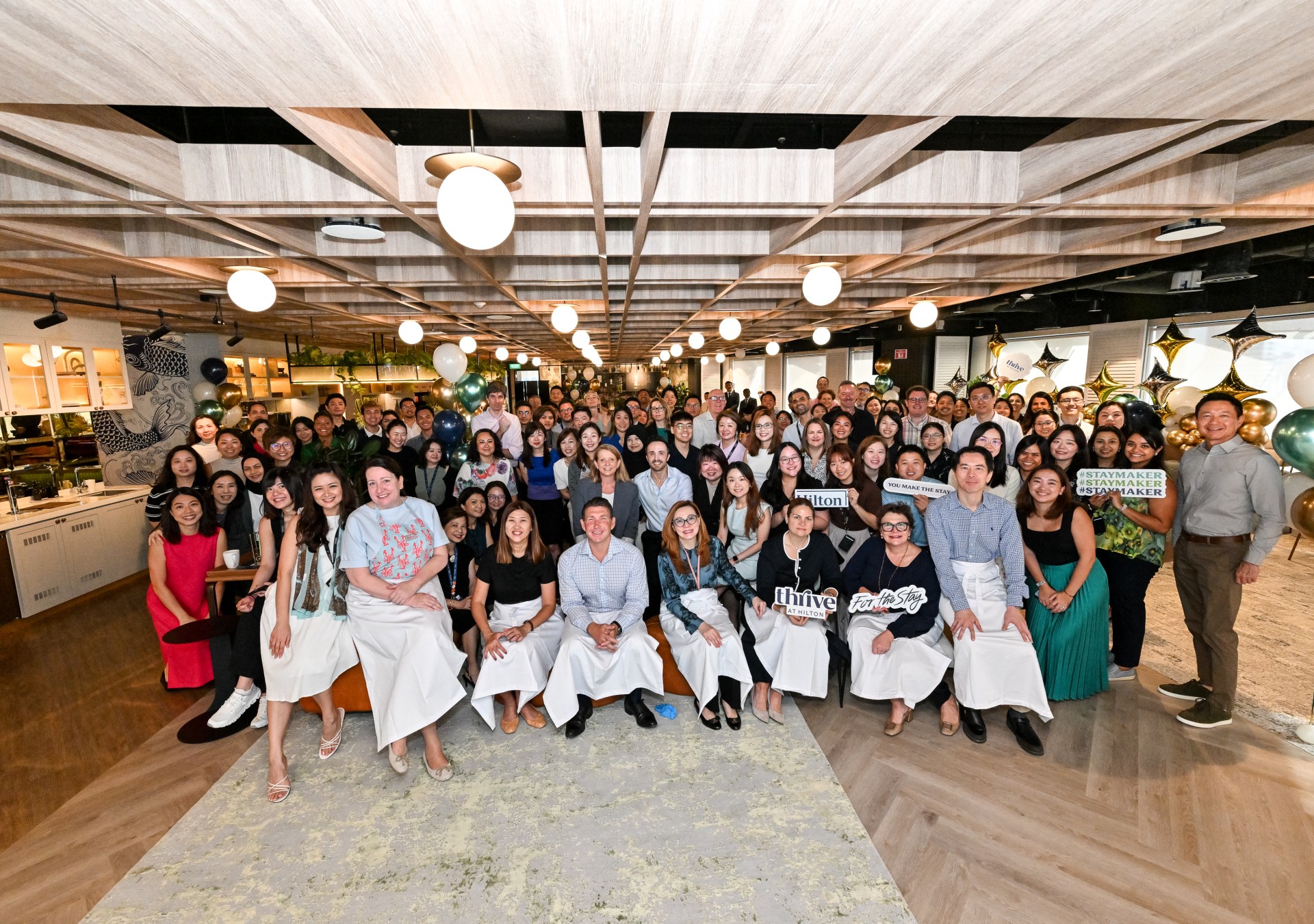 Large group of Hilton Team Members pose for a photo while celebrating Hilton being named No. 1 Best Place to Work in Asia 2025