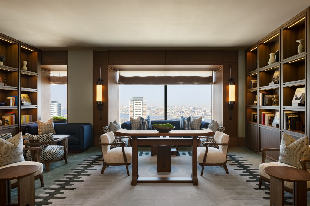 Waldorf Astoria Osaka - The Library, small library of books with couches and chair and view overlooking the city.