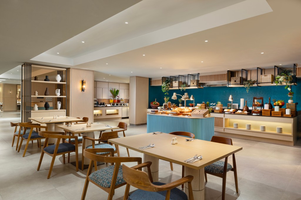 A restaurant with buffet line, tables, and chairs