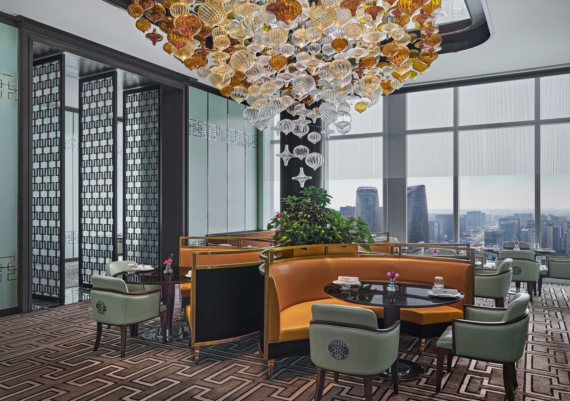 Waldorf Astoria Chengdu - Infinite Luck 成都华尔道夫酒店运·中餐厅, dining area with colorful bench seating, dining room with colorful blown glass strung from ceiling, dining room with view of city
