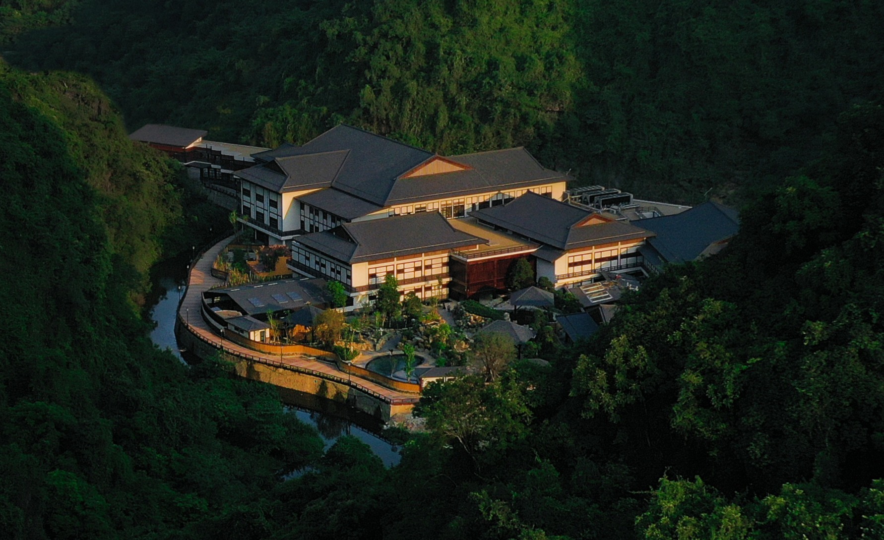 An aerial photo of the Hilton Quang Hanh Onsen Resort surrounded by trees