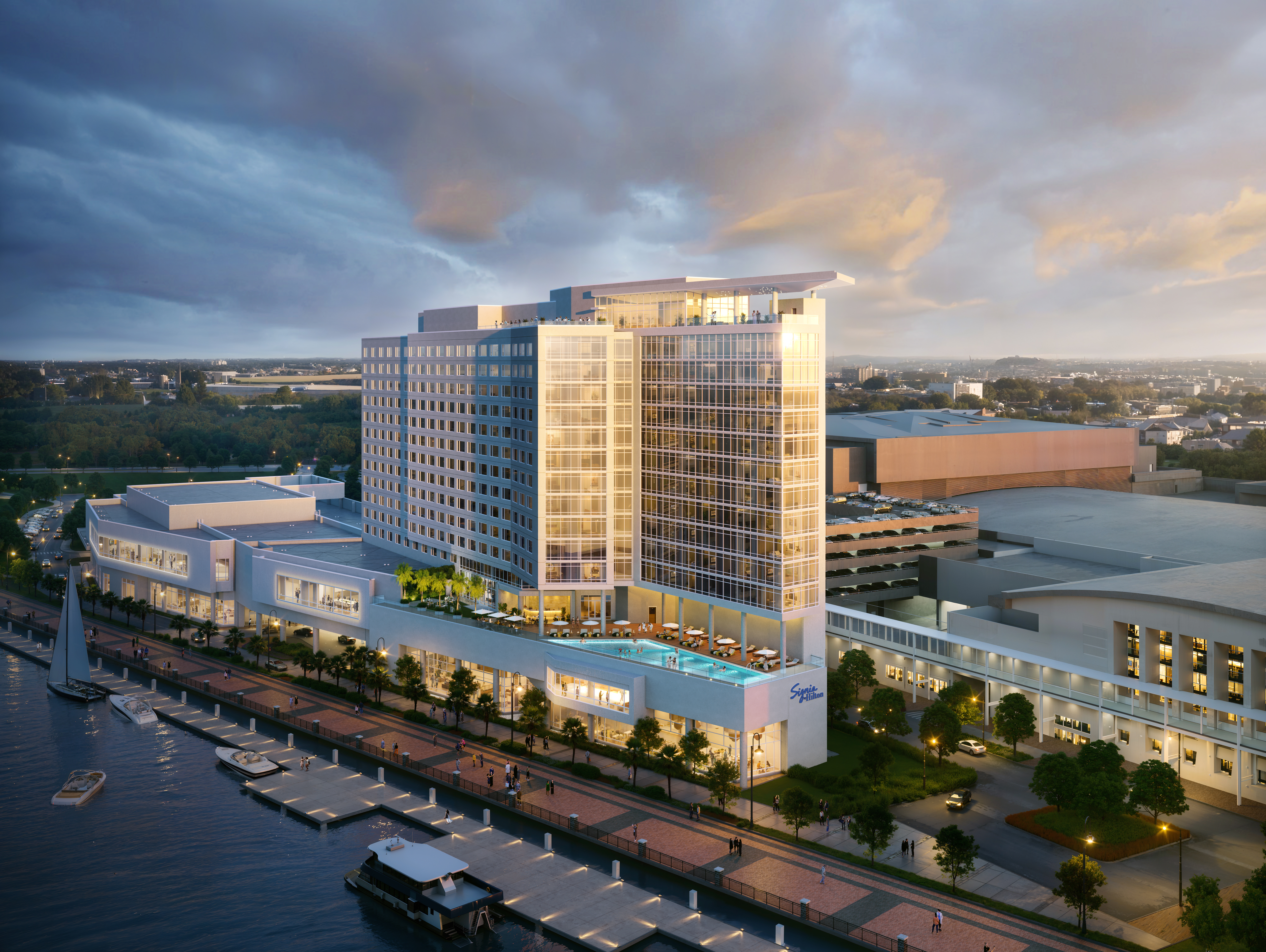 The exterior of the hotel with the water and boardwalk running in front