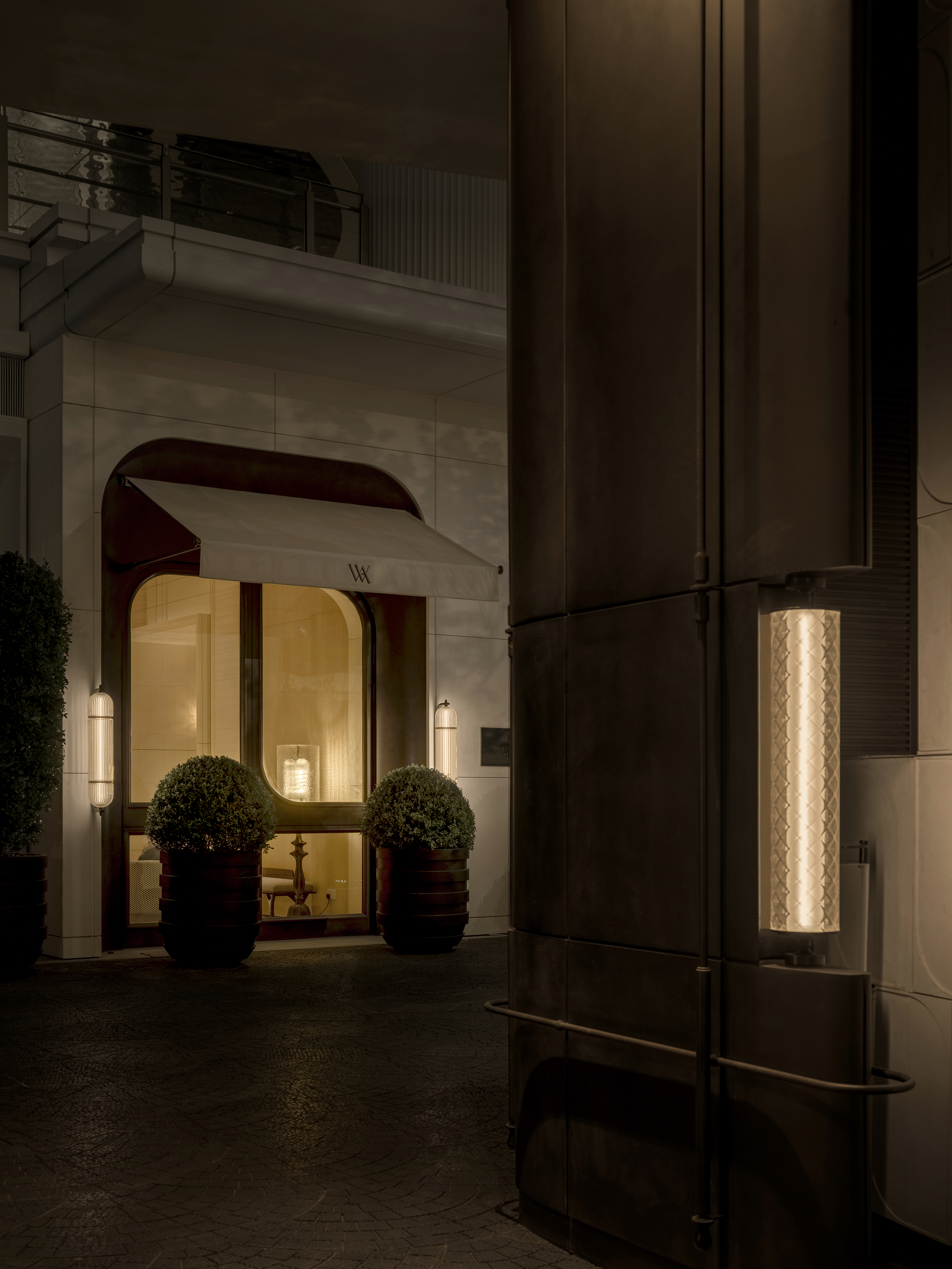A door of the hotel warmly lit at night