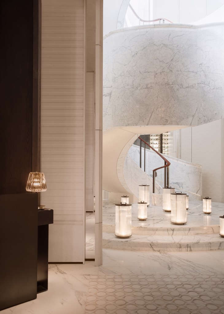 A marble staircase with lanterns at the base