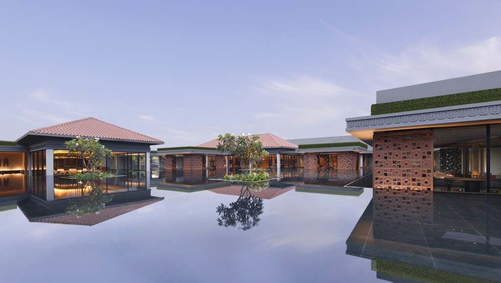 Still water creates reflections between the buildings