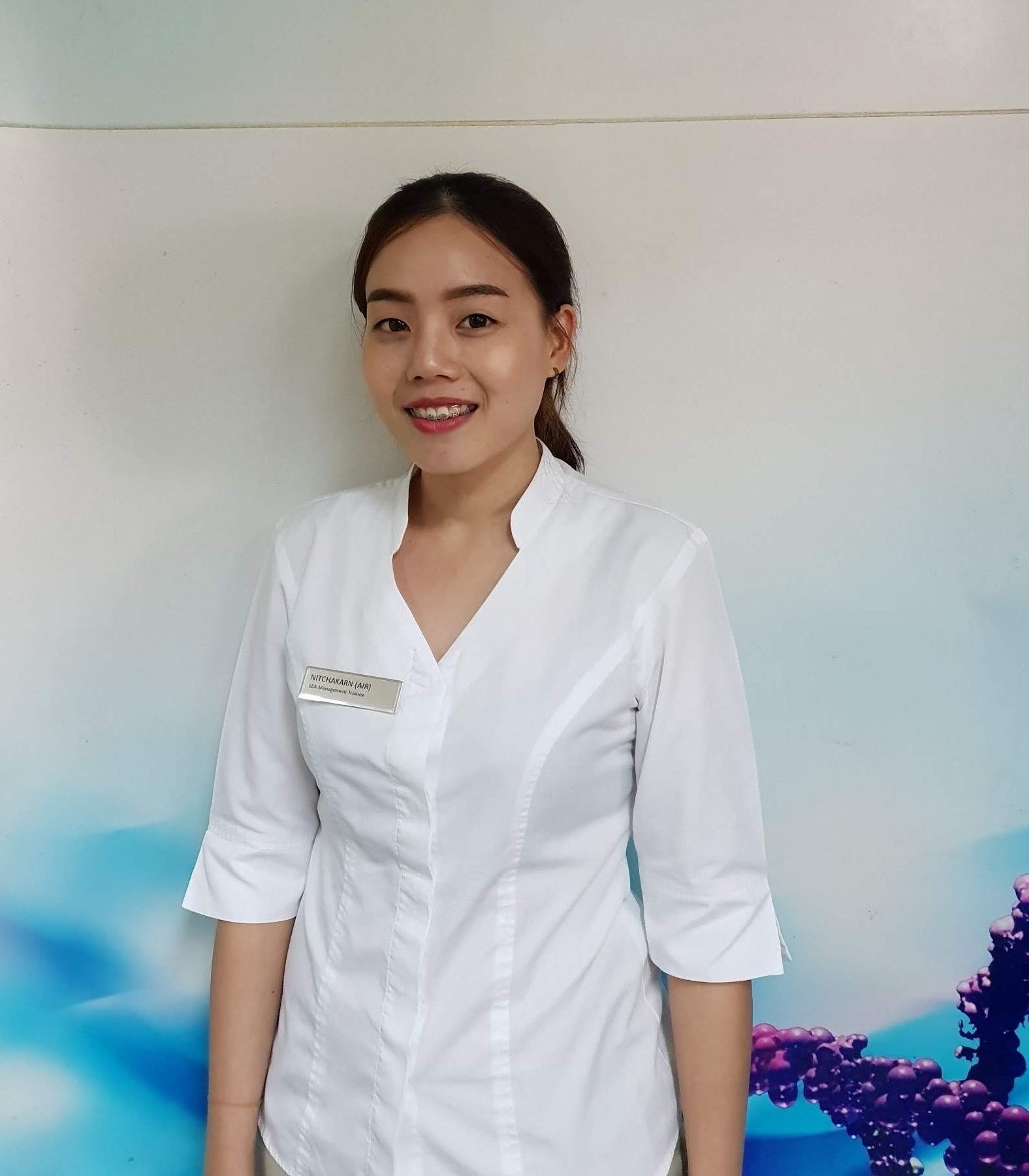 Nitchakarn Prasoppol smiling at camera