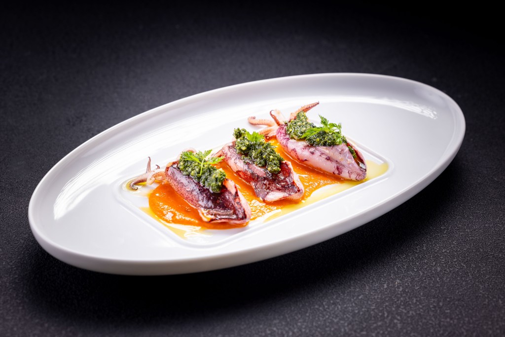 three calamari on a plate with sauce