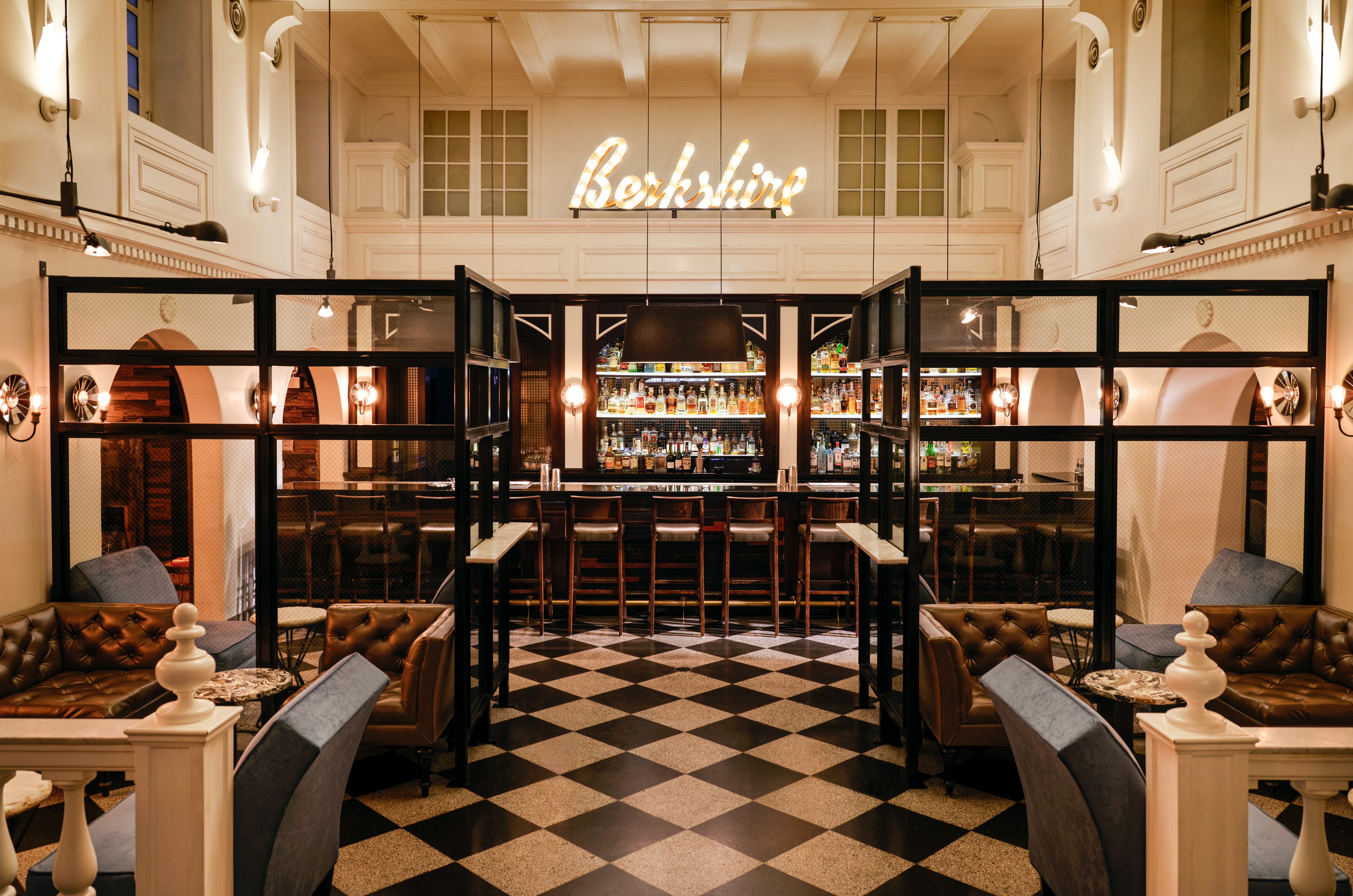 ACME Hotel Chicago - Bar, bar with various seating areas, large lighted "Berkshire" sign, black and white tile floor