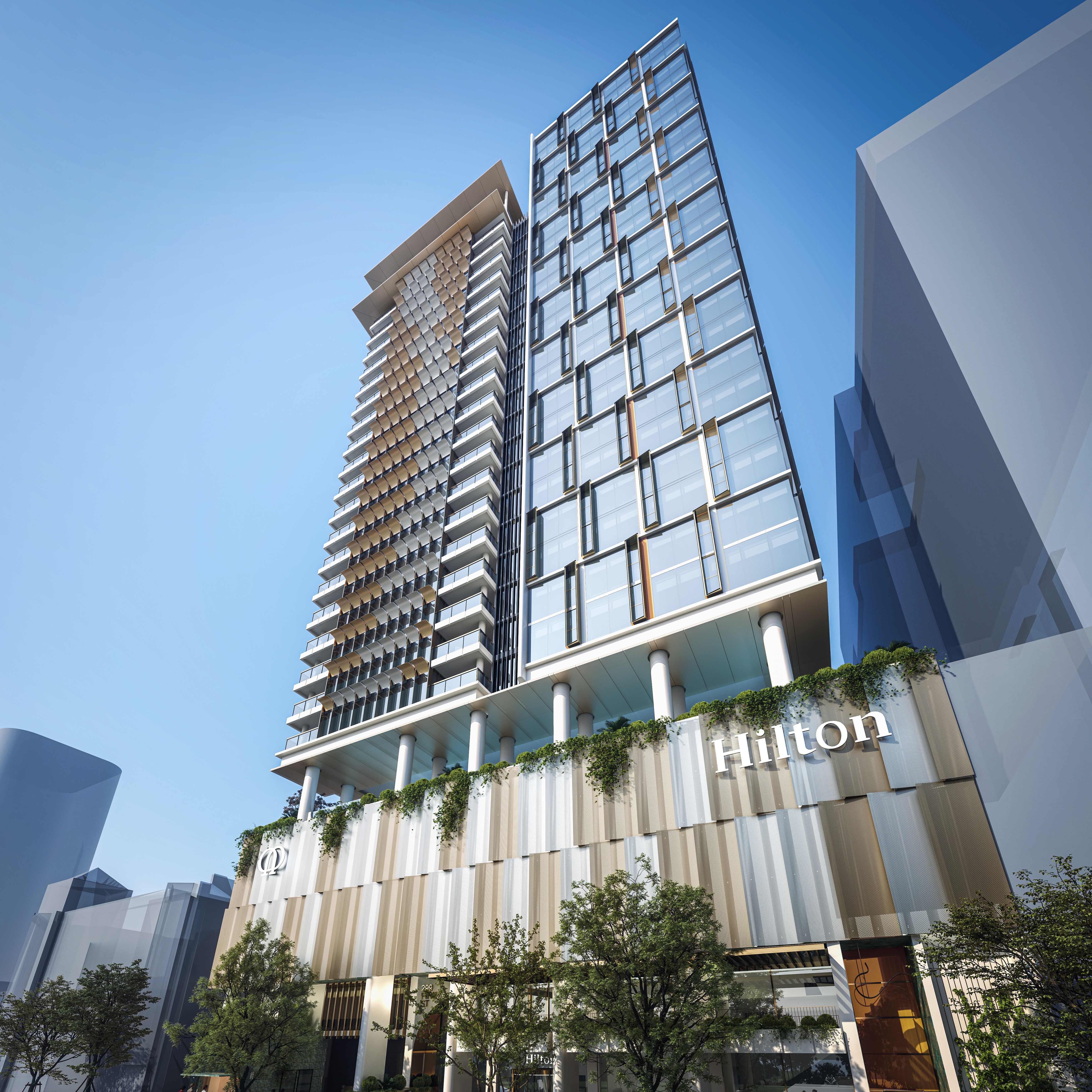 Modern Hilton hotel building with glass facade and vertical garden on the lower levels under a clear blue sky.