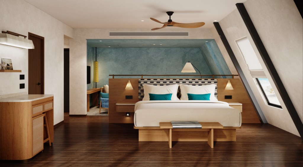 Modern guest room at Coco de Mer Maldives, Tapestry Collection by Hilton with a large bed featuring teal pillows, wooden furniture, a ceiling fan, and a slanted window with a view outside.