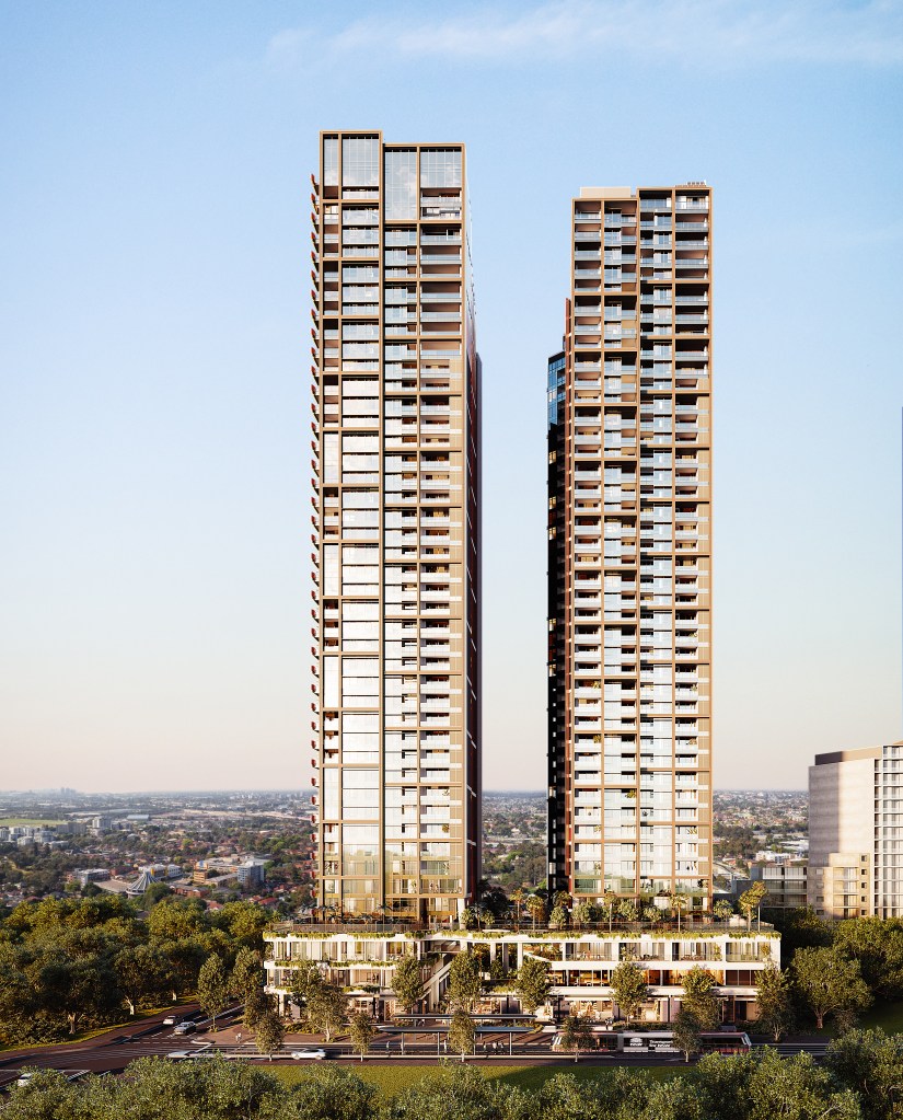 DoubleTree by Hilton Parramatta two tall modern towers with glass balconies rise above a green urban area.
