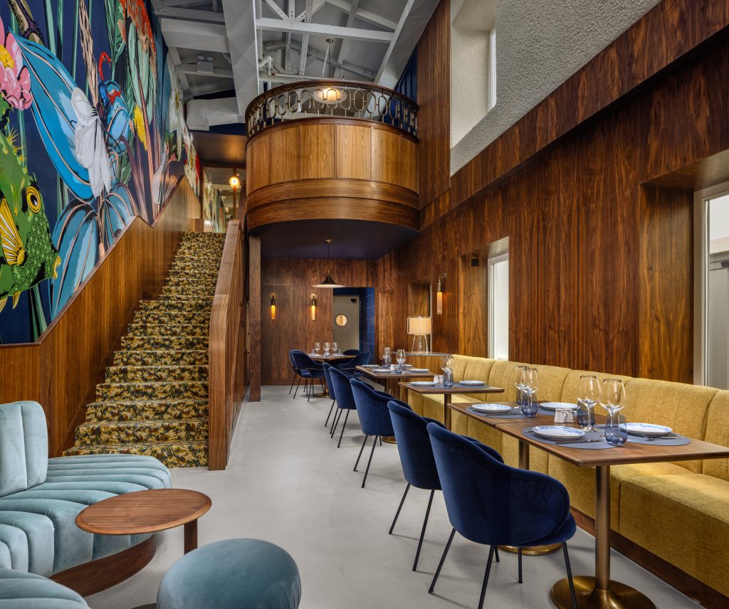 staircase, art wall and restaurant seating at Novo Mundo Stairs - DUO Hotel Lisbon, Curio Collection by Hilton
