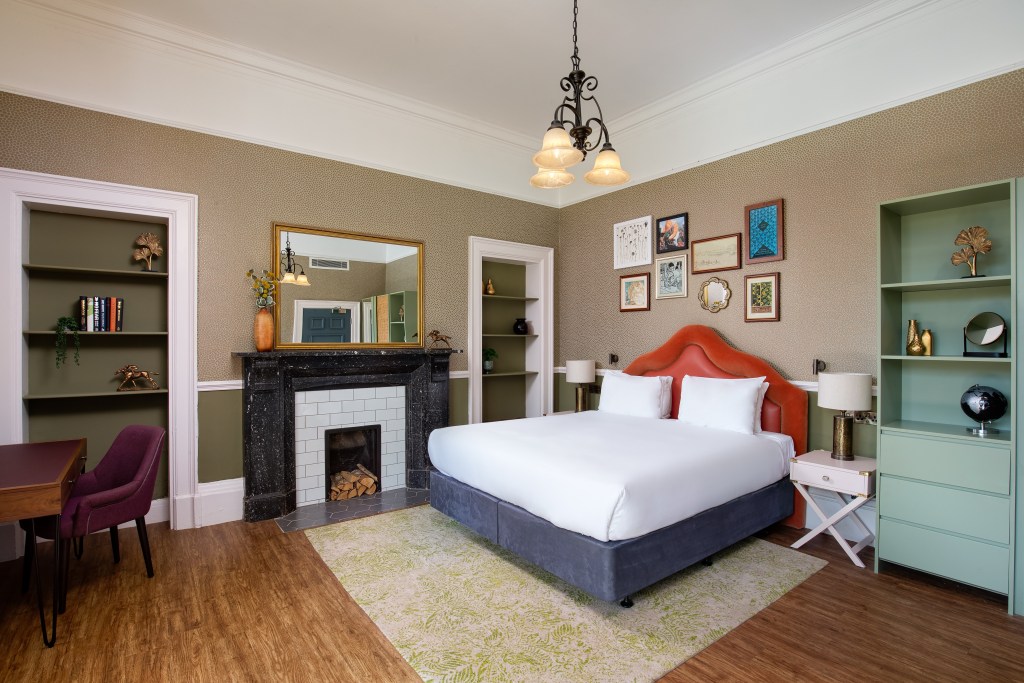 guest room with king bed, fireplace, bookshelves, desk and artwork - Elmbank York, Tapestry Collection by Hilton - King Lodge Junior Suite