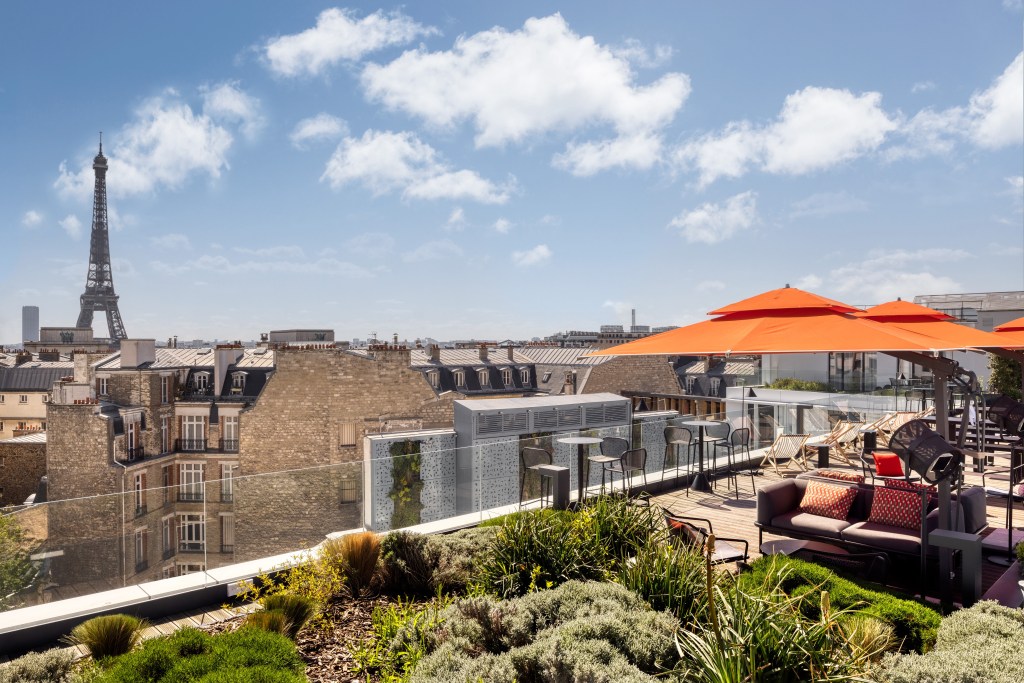 Canopy by Hilton Paris Trocadero - Rooftop Terrace, greenery, tables, chairs, orange umbrellas, view of Eiffel Tower