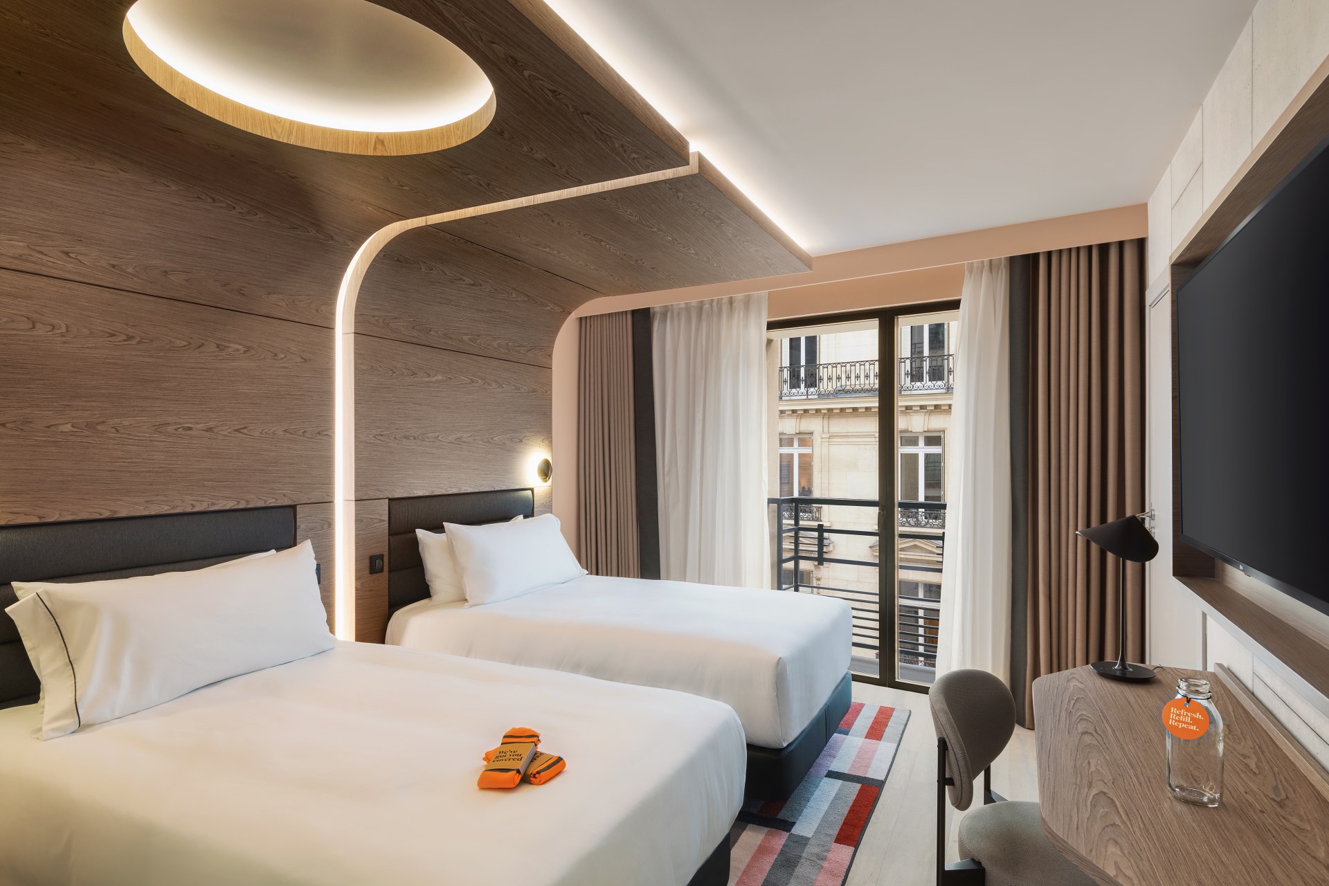 Canopy by Hilton Paris Trocadero - Twin Premium Guest Room, beds, chair, desk, glass bottle on a desk with desk lamp