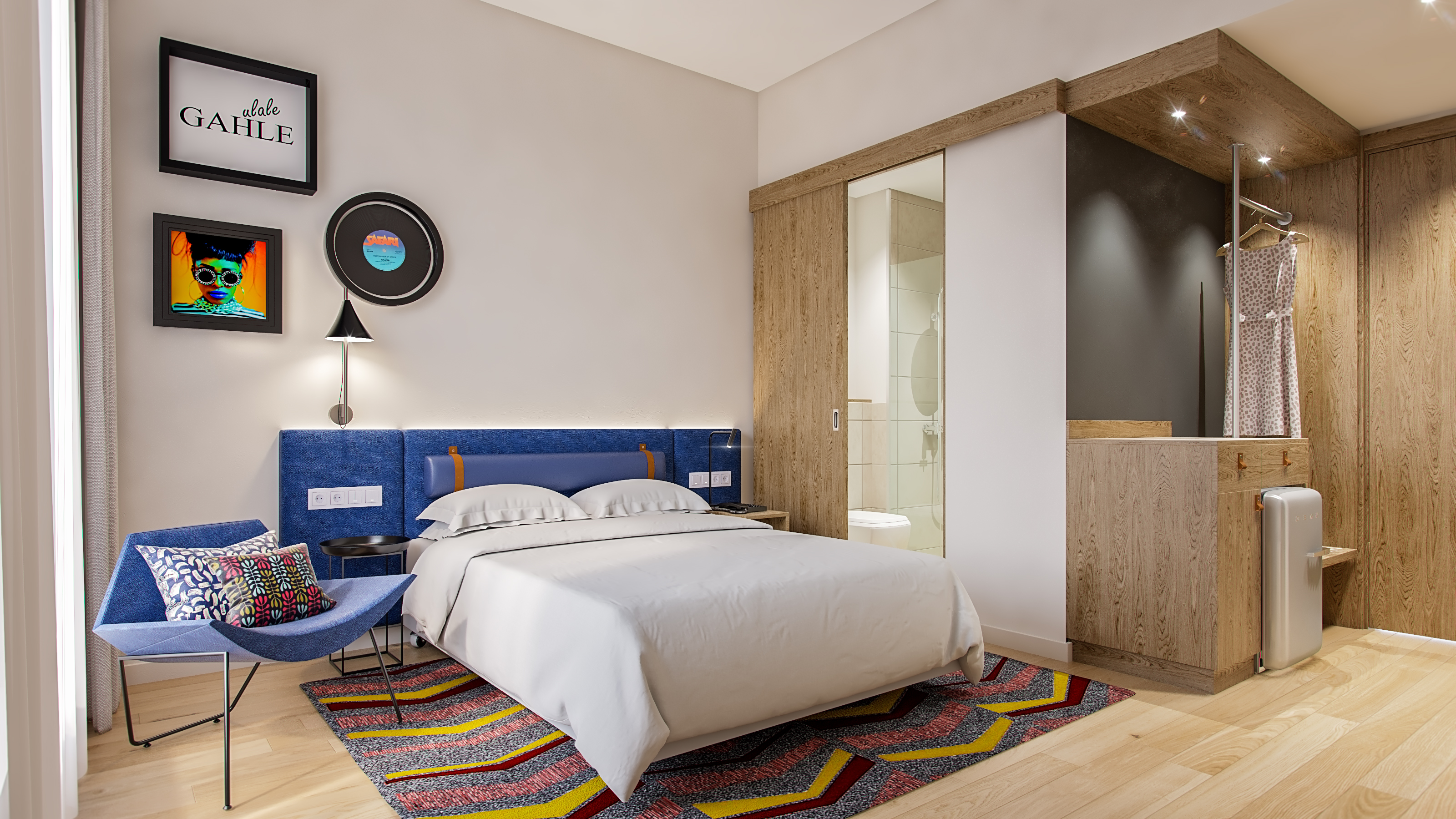 bed, chair with pillow, bathroom sliding door, dress hanging in an open closet area