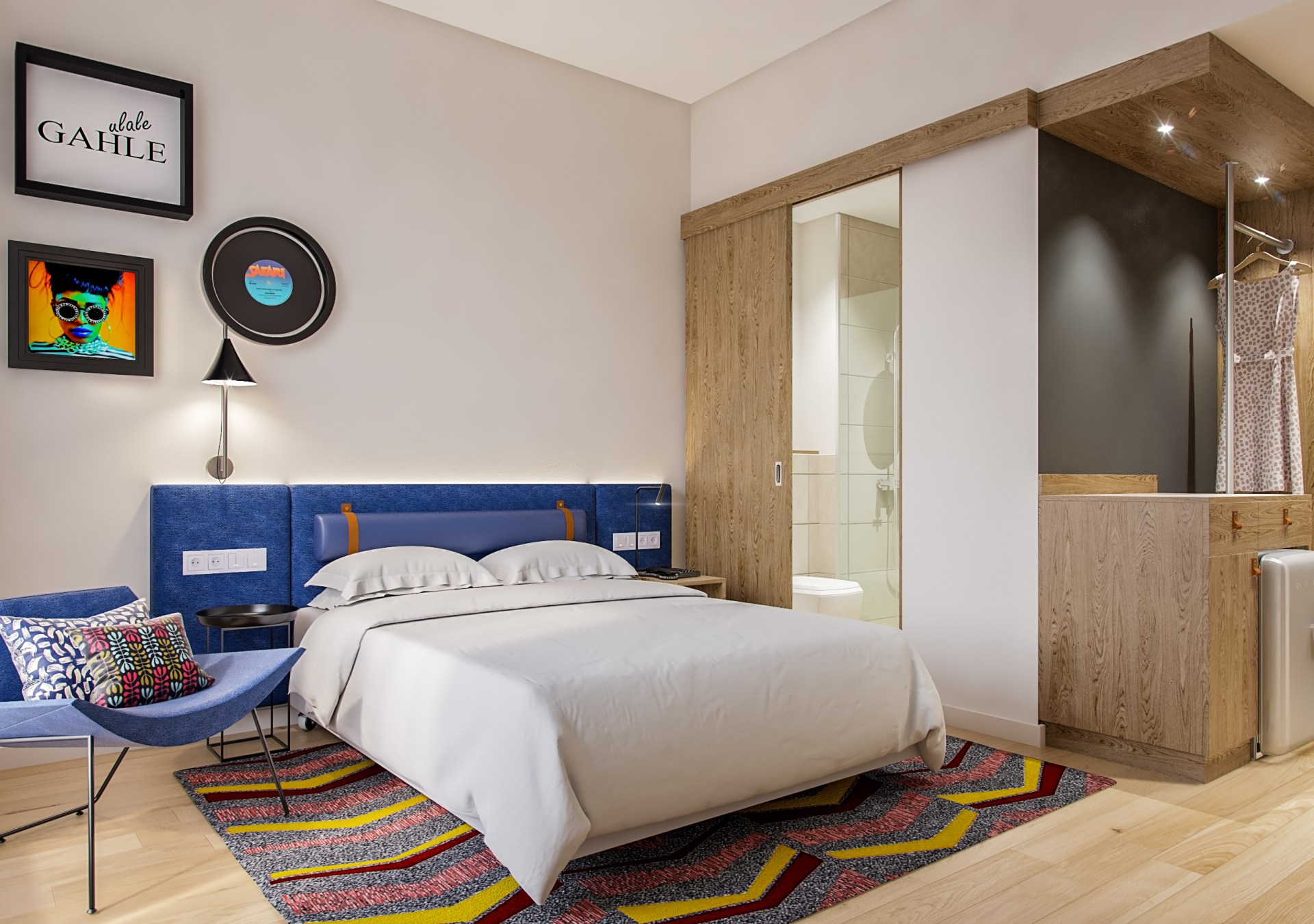 bed, chair with pillow, bathroom sliding door, dress hanging in an open closet area