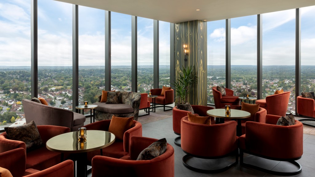 Hilton Woking - Loft, lounge like area with chairs and tables, windows with views or the surrounding area