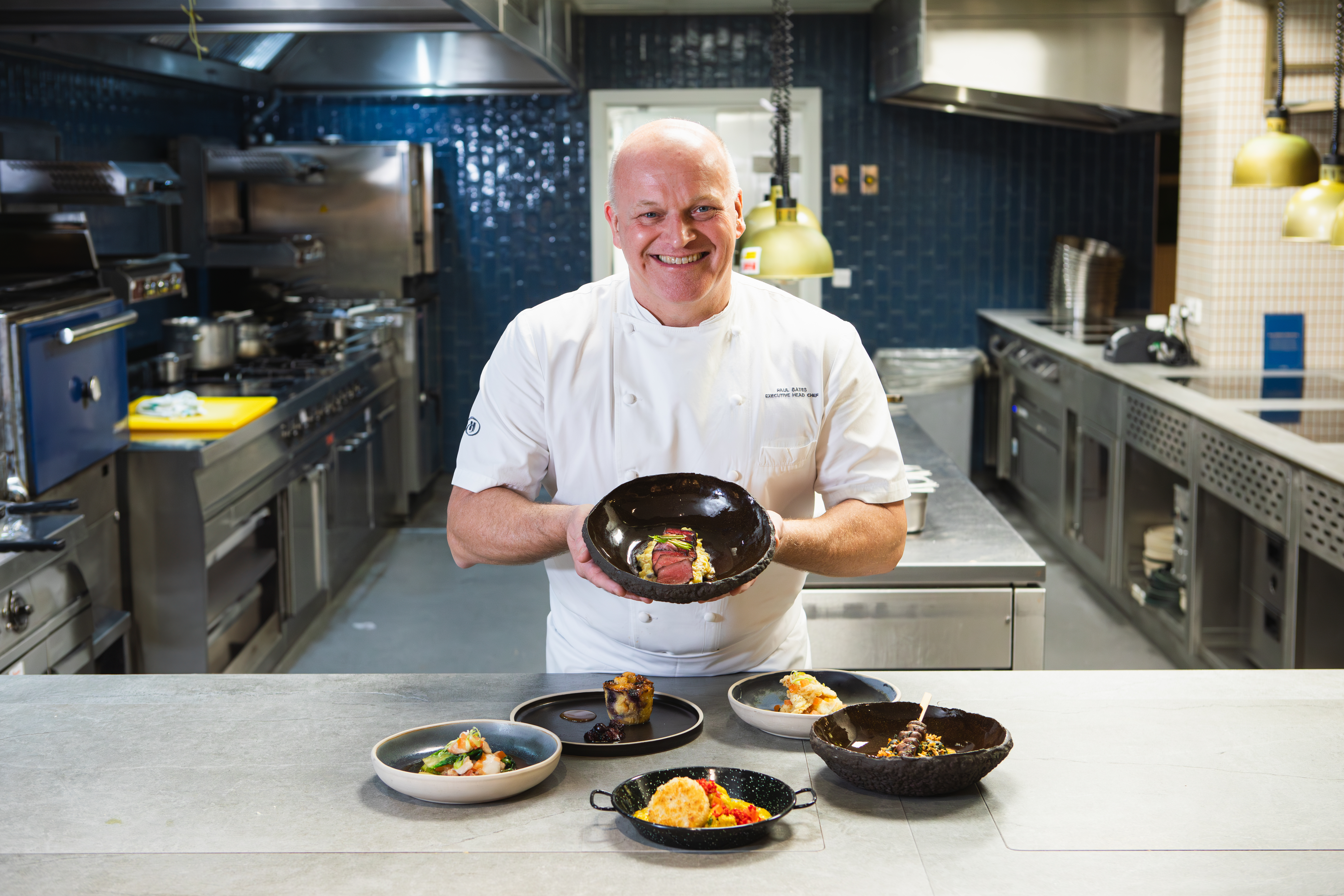 Chef Paul bates in the kitchen showing off his beautiful and delicious food dishes