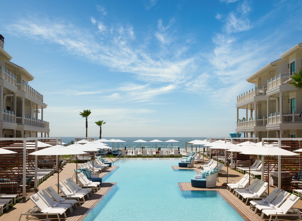 The Shore House at Hotel Del Coronado, LXR Hotels &amp; Resorts, Oceanfront Pool view with lounge seating and umbrellas and balconies and palm trees