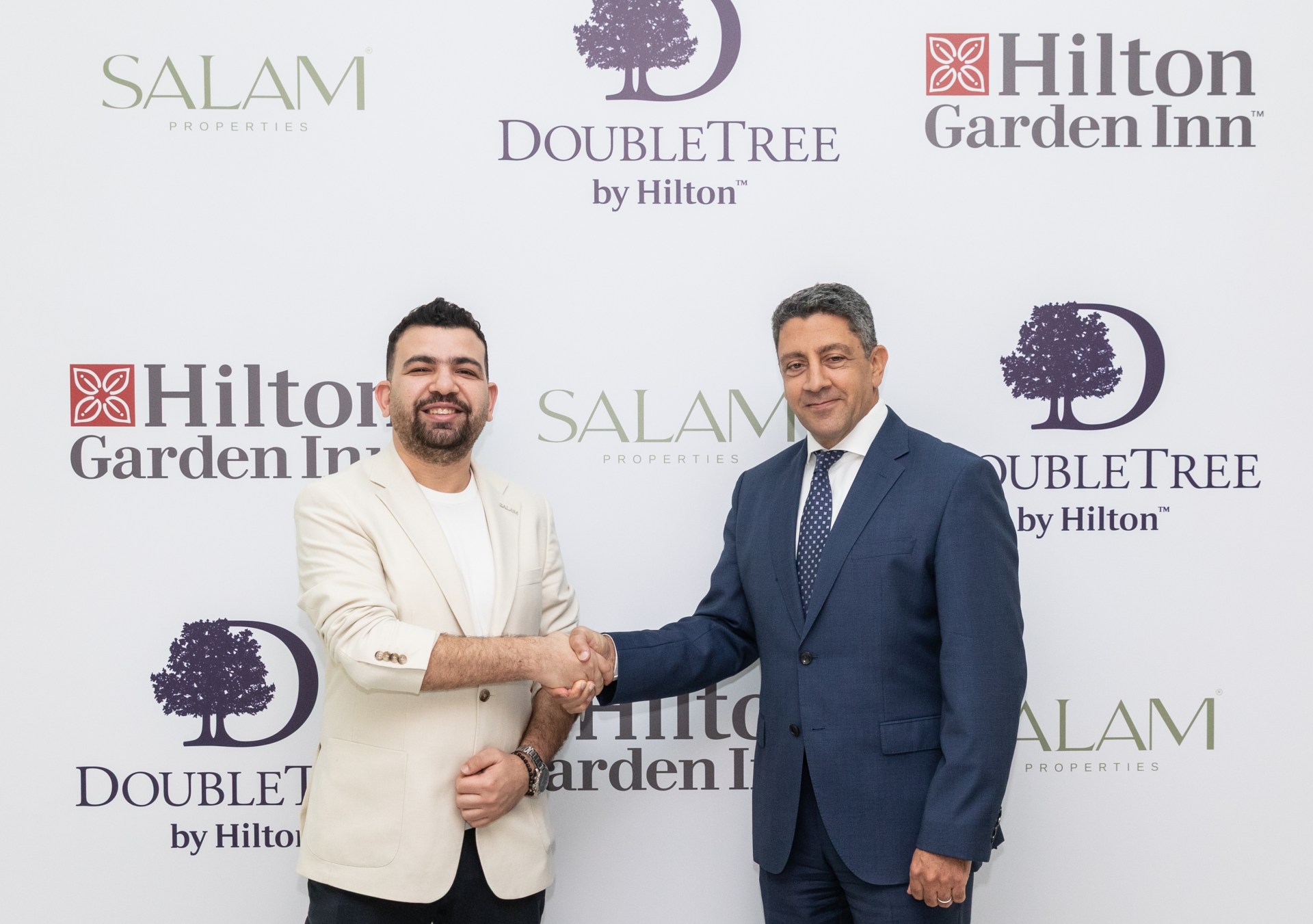 Ahmed Kassem, Vice Chairman and CEO of Salam Properties and Carlos Khneisser, VP Development MEA, Hilton shaking hands