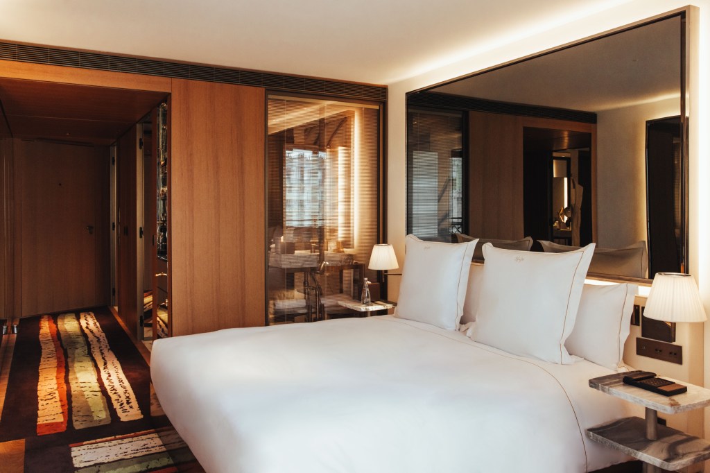 Sax Paris, LXR Hotels & Resorts - King Room,king bed with side table, mirror above bed, and view of door