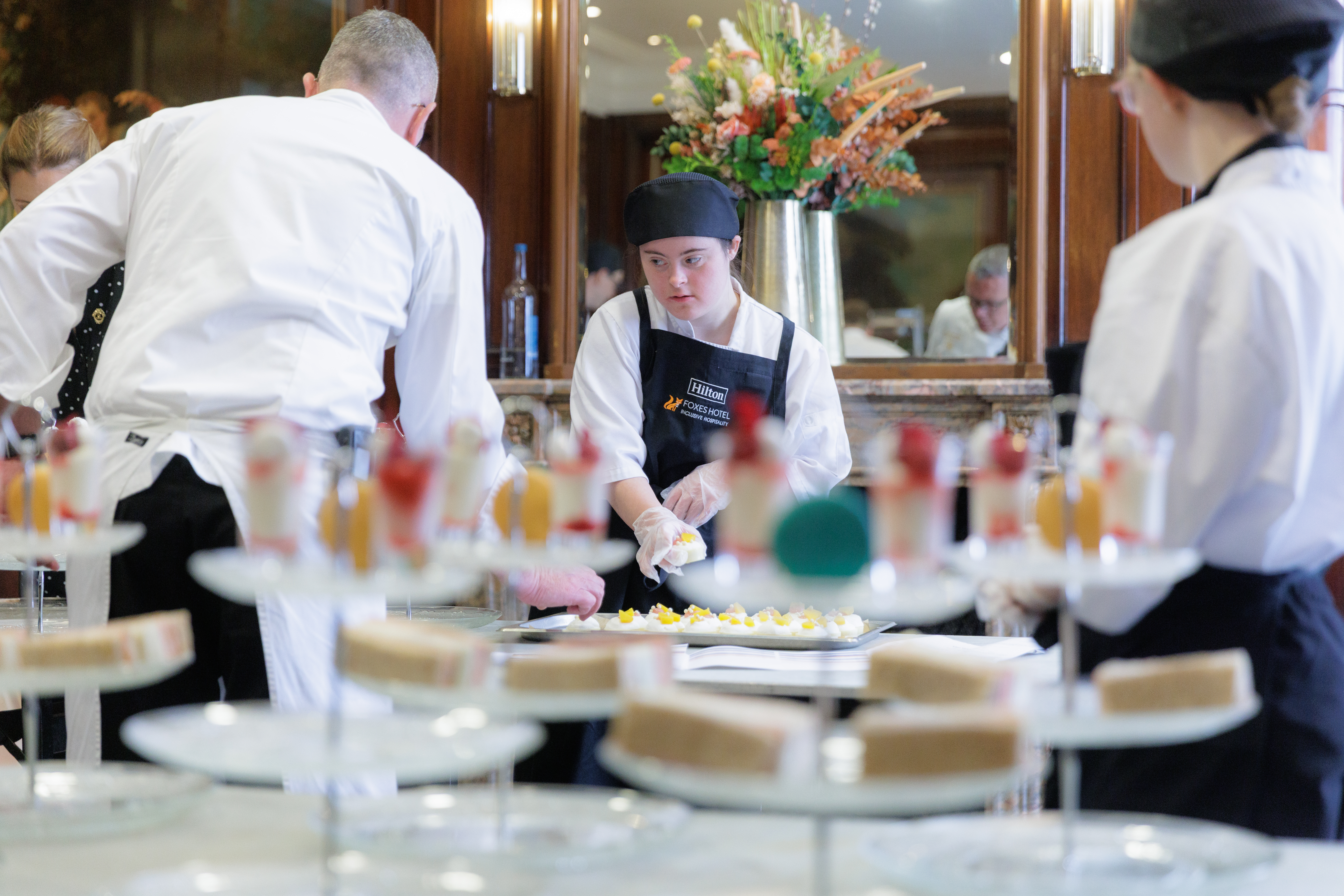 Hilton A Meal to Change Minds event with Aurora Foxes Student Preparing food for guests