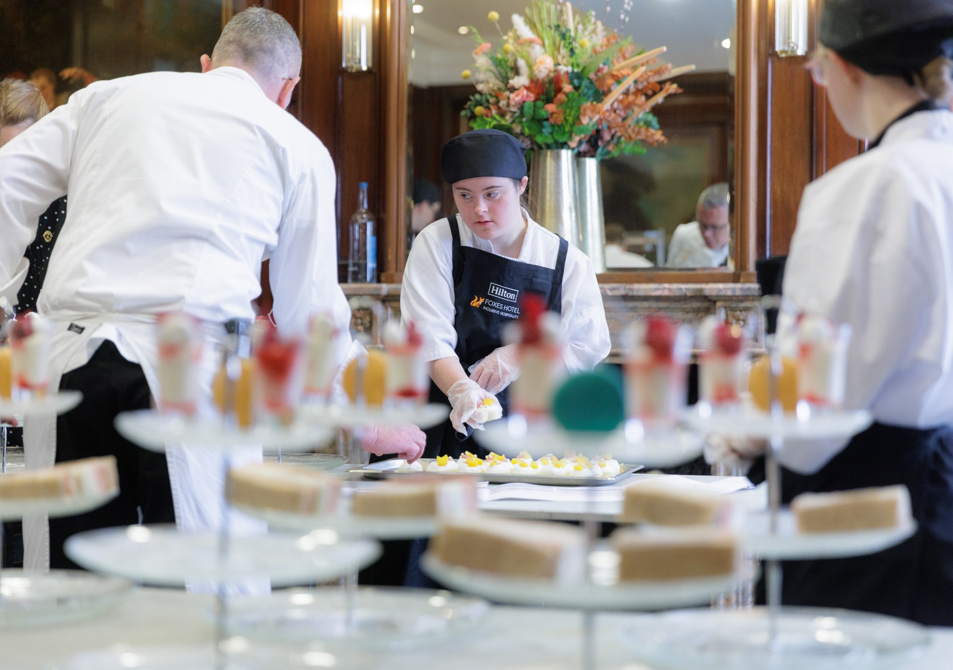 Hilton A Meal to Change Minds event with Aurora Foxes Student Preparing food for guests