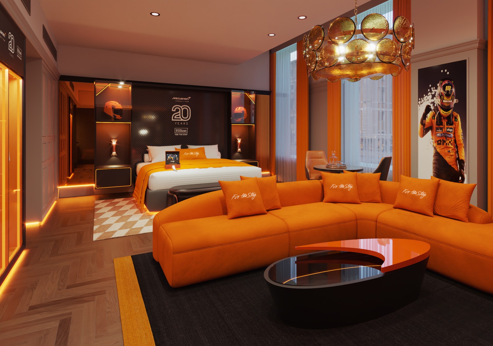Stay Like McLaren Racing Suite at The Trafalgar St. James London, Curio Collection by Hilton - Wide shot of suite with bed, seating, papaya colored accents