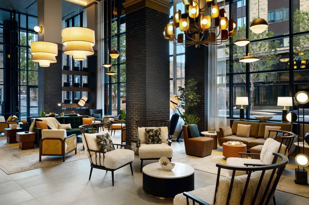 Tempo by Hilton Raleigh - Lobby with plush seating and several hanging light fixtures, large windows