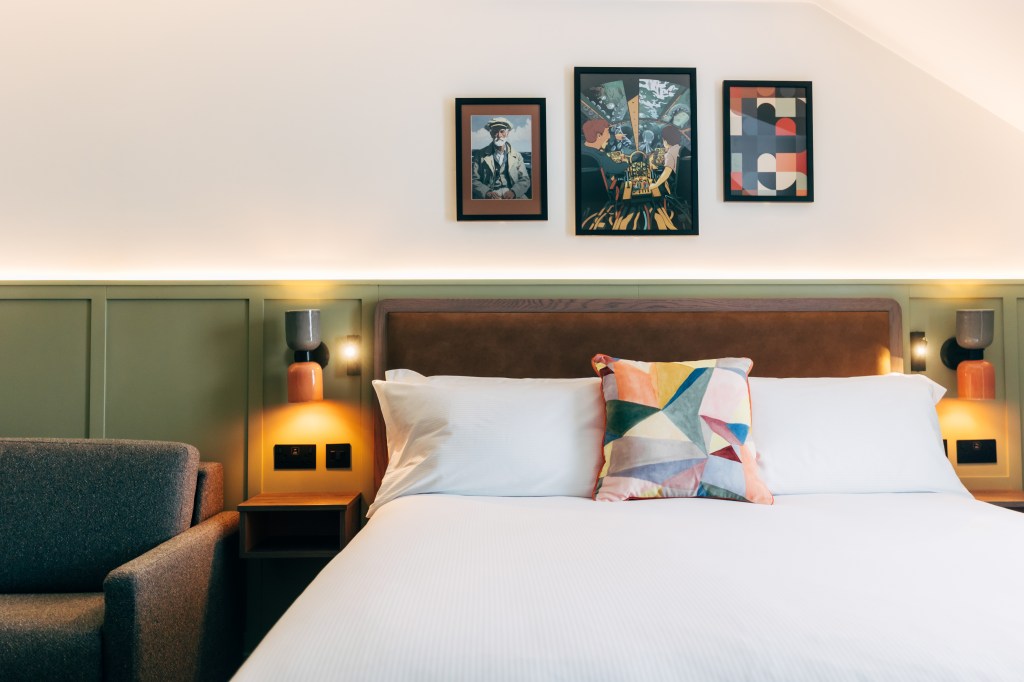 Guest Room Bedroom with white bedding, nautical themed artwork on the wall at The Marcus Portrush, Tapestry Collection by Hilton -