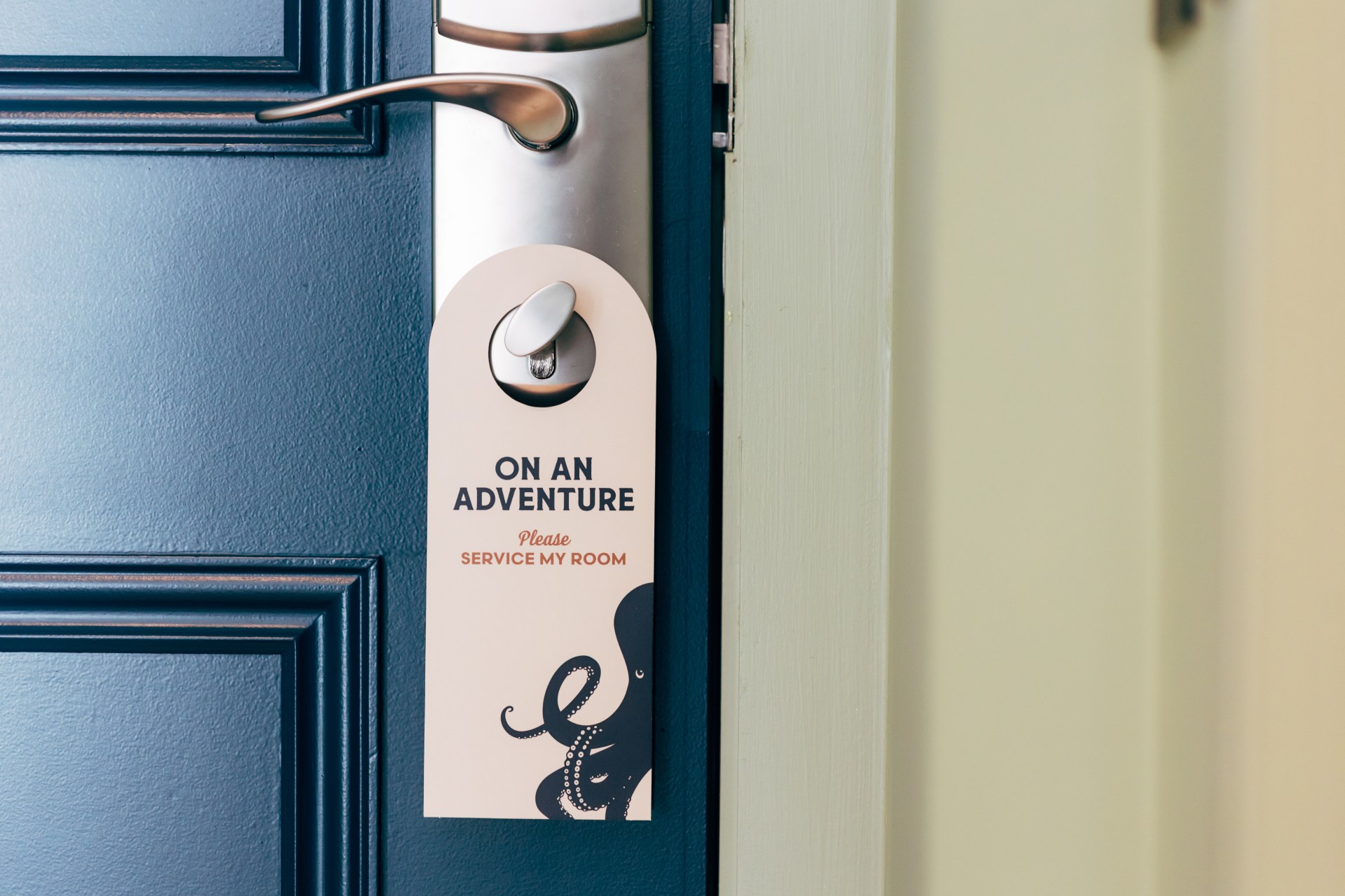 room signage/door hanger that reads "On an adventure, please service my room" at The Marcus Portrush, Tapestry Collection by Hilton