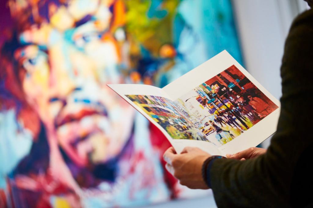 Conrad Algarve, ArtCatto Private Gallery, person holding gallery pamphlet