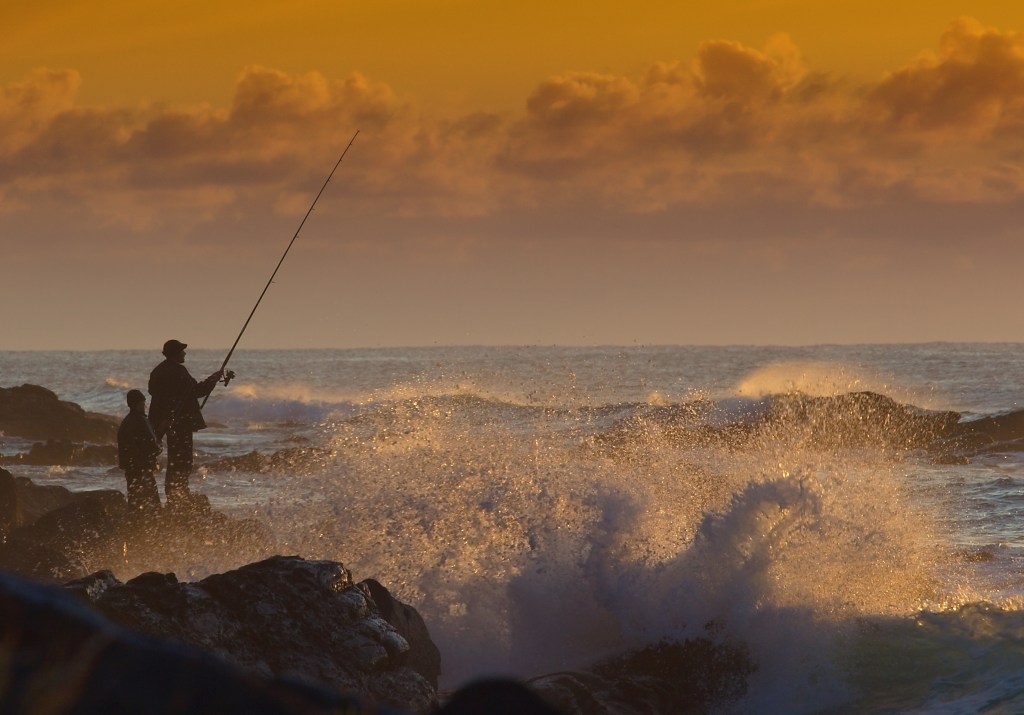 Conrad Rabat Arzana Fisherman at sunrise, waves crashing, Father and son fishing